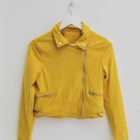 yellow jacket hung on rack in diy fashion studio workshop space - fashion stock-fotos und bilder