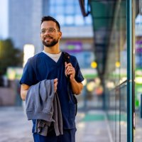 young adult male nurse traveling through the city - travel stock pictures, royalty-free photos & images