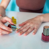 young adult painting her nails at home with nail polish - nails art stock pictures, royalty-free photos & images