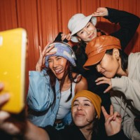 young adult women wearing cool street style clothes are taking a selfie at night - fashion stock pictures, royalty-free photos & images