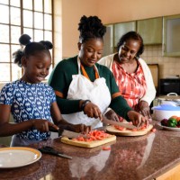 young african girl cooking with mother and grandmother - food stock pictures, royalty-free photos & images