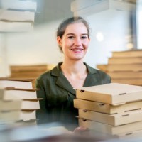 young and female small business owner with pizza boxes - junk food stock pictures, royalty-free photos & images