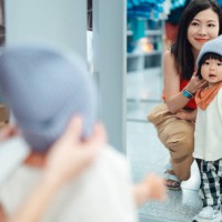 young asian mother shopping with her toddler in clothing store - fashion stock pictures, royalty-free photos & images