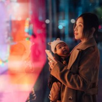 young asian mother using smartphone while doing christmas shopping with her daughter - fashion stock pictures, royalty-free photos & images