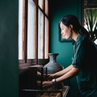 young asian woman decorating and arranging picture frames and home decorations over the cabinet at home. enjoying her time at cozy home - home decoration stock pictures, royalty-free photos & images