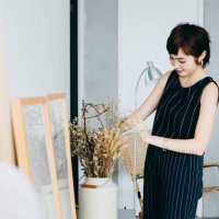 young asian woman decorating and arranging a vase with dried plants on cabinet in the living room at home - home decoration stock pictures, royalty-free photos & images