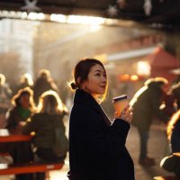 young asian woman drinking coffee at local street food market with moody sunlight - travel stock-fotos und bilder