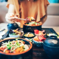 young asian woman enjoying japanese food-eel rice. - food stock pictures, royalty-free photos & images