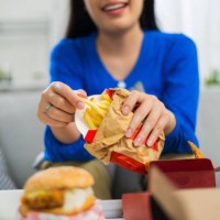 young asian woman happy about the fast delivery of food - junk food stock pictures, royalty-free photos & images