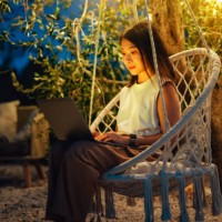 young asian woman using laptop in the garden at night - garden decoration stock pictures, royalty-free photos & images