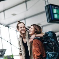 young backpacker couple at the airport - travel stock pictures, royalty-free photos & images