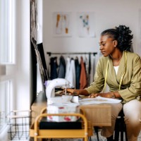 young beautiful female clothing designer drawing sketches at workshop - fashion stock pictures, royalty-free photos & images