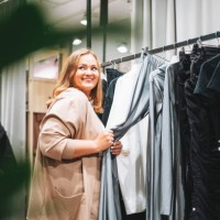 young beautiful woman plus size chooses clothes at store - fashion stock pictures, royalty-free photos & images