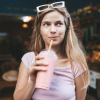 young blonde woman drinking strawberry smoothie,chiang mai,thailand - junk food stock pictures, royalty-free photos & images