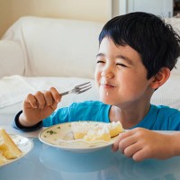 young boy eating a slice of cake - junk food stock pictures, royalty-free photos & images