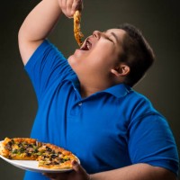 young boy having a slice of pizza. (obesity) - junk food stock pictures, royalty-free photos & images