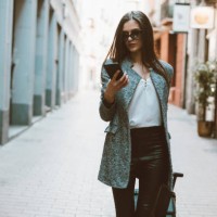 young businesswoman in the city checking cell phone - fashion stock pictures, royalty-free photos & images