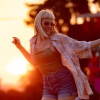 young carefree woman having fun while dancing on a music festival at sunset. - concert stock pictures, royalty-free photos & images