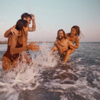 young cheerful couples having fun during summer vacation in sea. - travel stock pictures, royalty-free photos & images