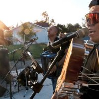 young chicano hispanic man singing performing in a latino band outdoors concert - concert stock pictures, royalty-free photos & images