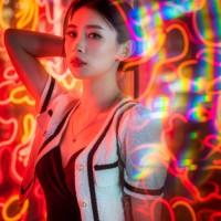 young chinese woman standing next to red neon lights - fashion stock pictures, royalty-free photos & images