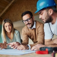 young couple analyzing blueprints with their construction worker/ - home decoration stock pictures, royalty-free photos & images