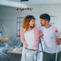 young couple choosing paint color from samples for new home interior design - home decoration stock pictures, royalty-free photos & images