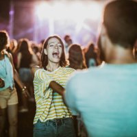 young couple dancing and singing on music concert by night. - concert stock pictures, royalty-free photos & images