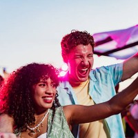 young couple dancing on party outdoors - concert stockfoto's en -beelden
