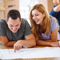 young couple deciding where to put all their furniture - home decoration stock pictures, royalty-free photos & images
