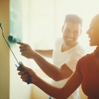 young couple decorating apartment. - home decoration stock pictures, royalty-free photos & images
