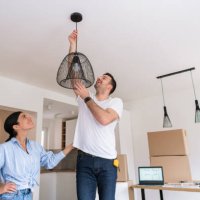 young couple decorating their new home in a modern style - home decoration stock pictures, royalty-free photos & images