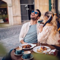 young couple drinking coffee and having fun at coffee shop - food stock pictures, royalty-free photos & images