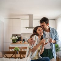 young couple drinking morning coffee enjoying the weekend in their new apartment - coffee stock pictures, royalty-free photos & images