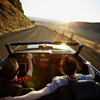 young couple driving convertible at sunset - travel stock pictures, royalty-free photos & images