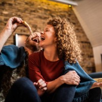 young couple eating pizza. - junk food stock pictures, royalty-free photos & images
