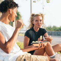 young couple enjoying a healthy meal outdoors in barcelona - junk food stock pictures, royalty-free photos & images