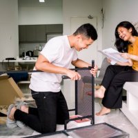 young couple helping each other assembling table - home decoration stock pictures, royalty-free photos & images