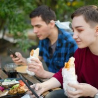 young couple in a cafe - junk food stock pictures, royalty-free photos & images