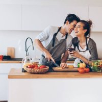 young couple in love in the kitchen - food stock pictures, royalty-free photos & images