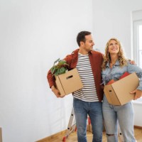 young couple in their new home - home decoration stock pictures, royalty-free photos & images