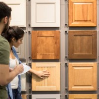 young couple look at cabinet samples in home improvement store - home decoration stock pictures, royalty-free photos & images