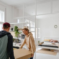young couple moving into a new apartment - home decoration stock pictures, royalty-free photos & images