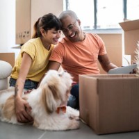 young couple packing and moving boxes at home - home decoration stock pictures, royalty-free photos & images
