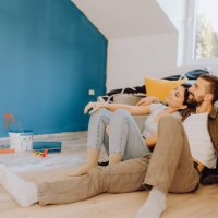 young couple paint together a wall in their apartment - home decoration stock pictures, royalty-free photos & images
