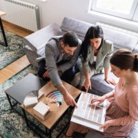 young couple pointing together at the color that they like - home decoration stock pictures, royalty-free photos & images