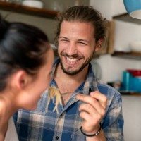 young couple preparing food together, tasting spaghetti - food stock pictures, royalty-free photos & images