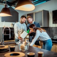young couple shopping together in a kitchen equipment store with a salesman helping them - home decoration stock pictures, royalty-free photos & images