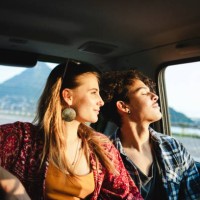 young couple traveling by car, sunset light - travel stock pictures, royalty-free photos & images