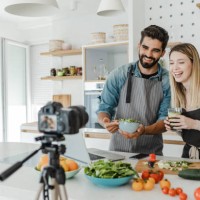 young couple vlogging in the kitchen - food stock pictures, royalty-free photos & images